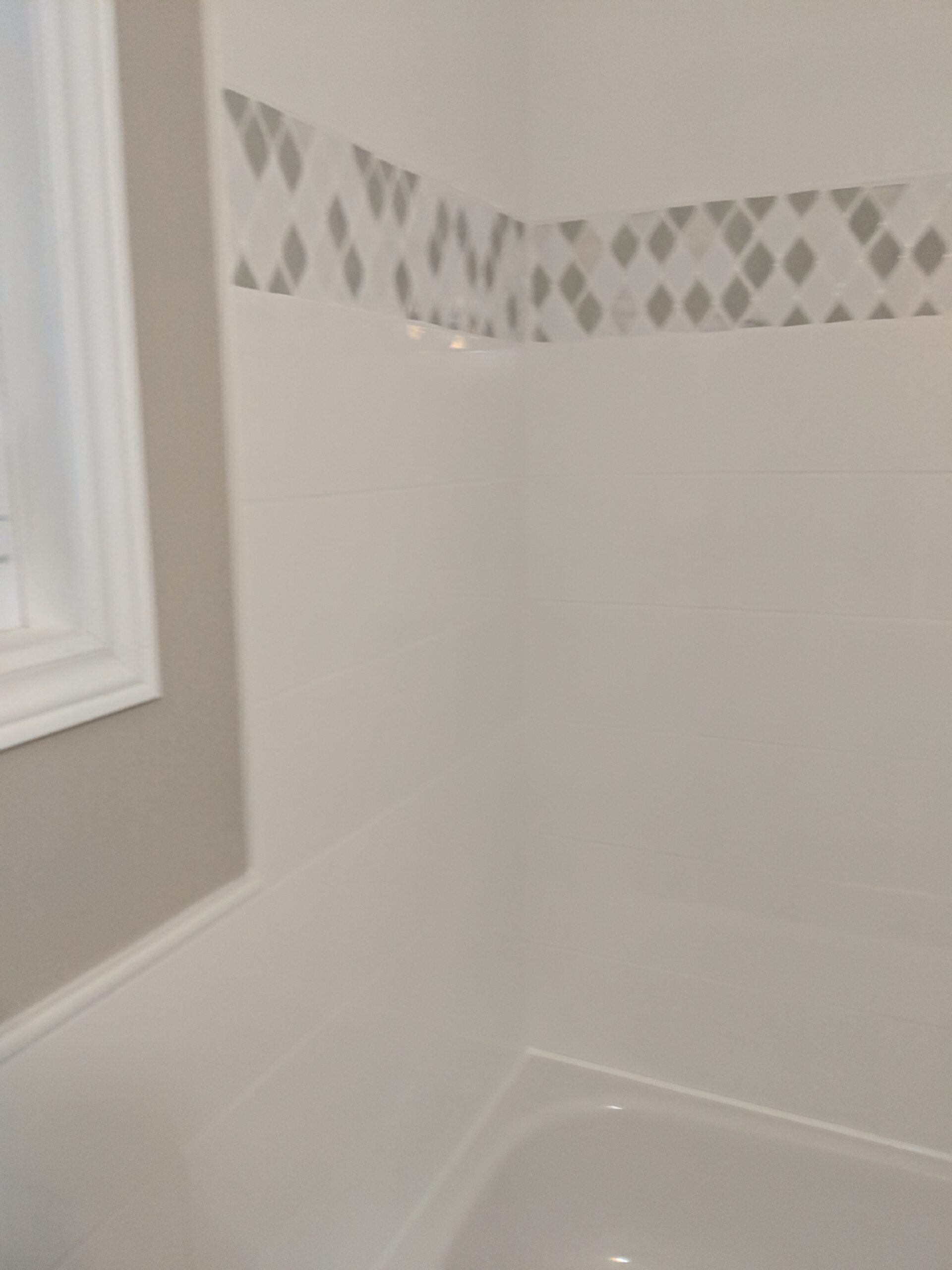 Custom bathroom renovation with new tile and paint in New Smyrna Beach Florida